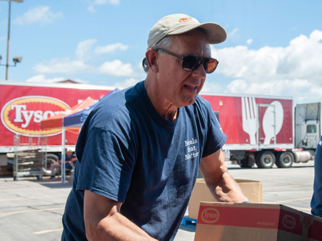 This is a photo of a man loading boxes.